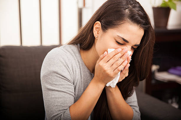 istock Cute girl blowing her nose 526422897