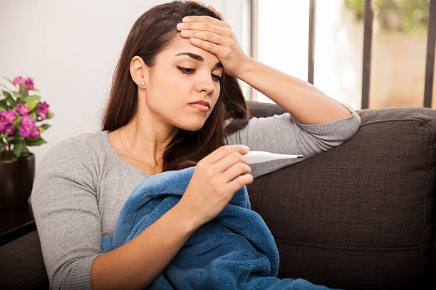 istock Young brunette with fever 526425759