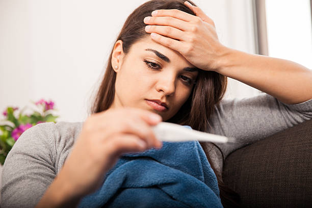 istock Beautiful girl with fever 526425763