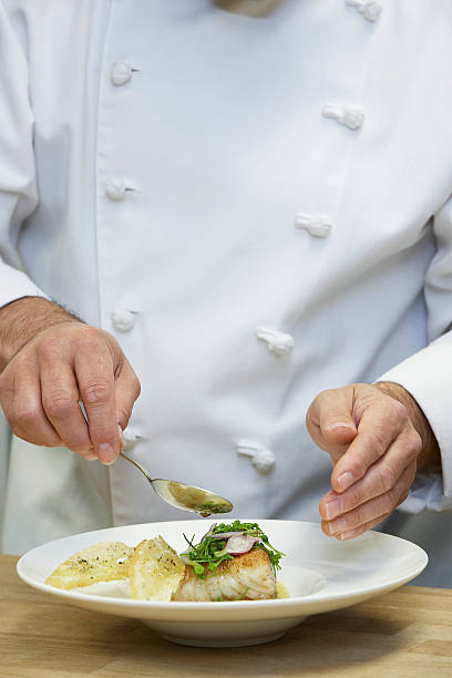 istock Chef Garnishing Food 526426343