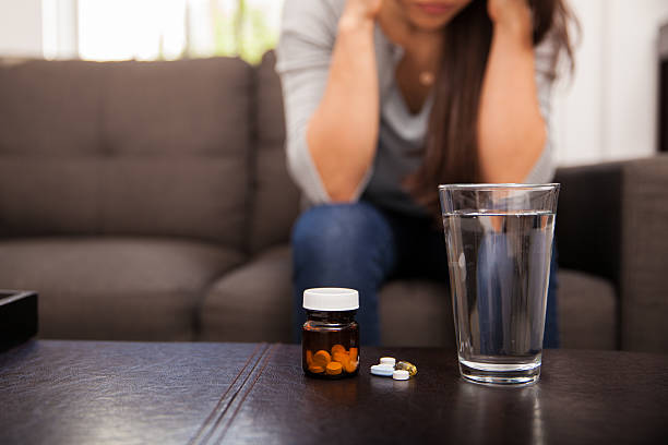 istock Glass of water and some pills 526426871