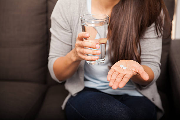 istock Young woman taking aspirin 526426923