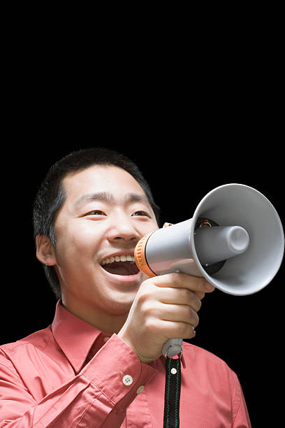 Chinese businessman talking into bullhorn