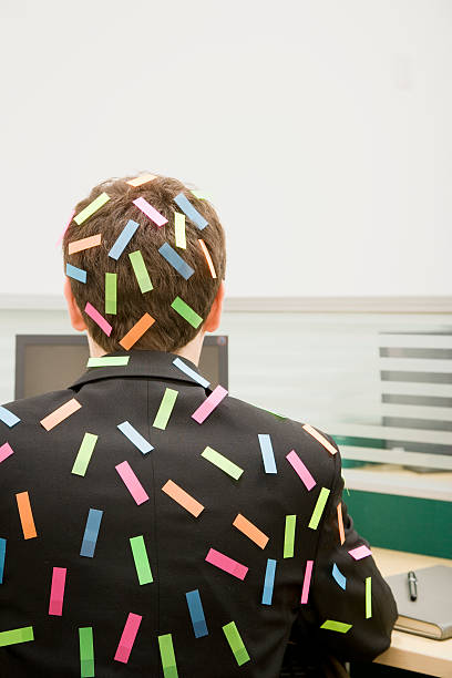 Man in Office at Desk Covered in Sticky Tabs Man in Office at Desk Covered in Sticky Tabs office fun business adhesive note stock pictures, royalty-free photos & images