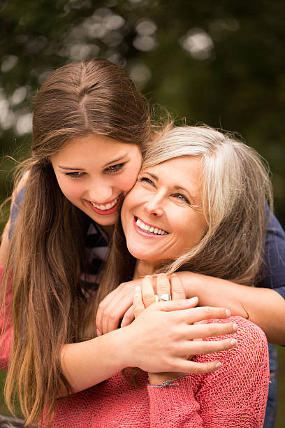 istock Daughter Surprises Mother With a Hug From Behind 526427761