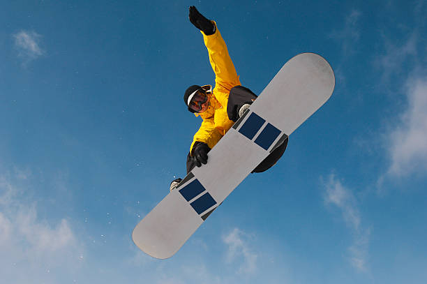 istock Snowboarder In Winter Clothes Jumping Against Sky 526440693