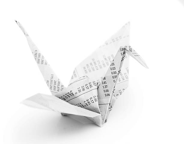 Origami crane bird from recycle newspaper stock photo