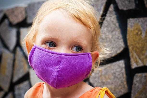 istock Cute little girl in bright face mask 526442309
