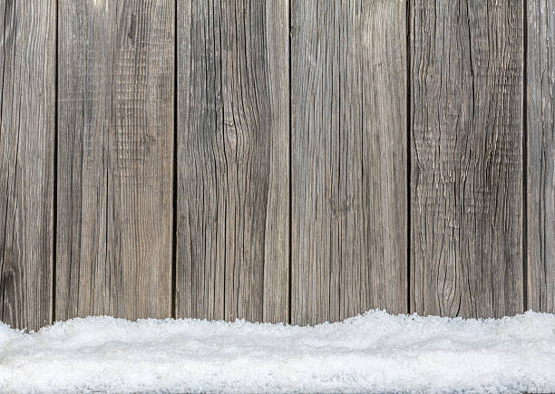 istock Old wooden  boards and white snow 526443489