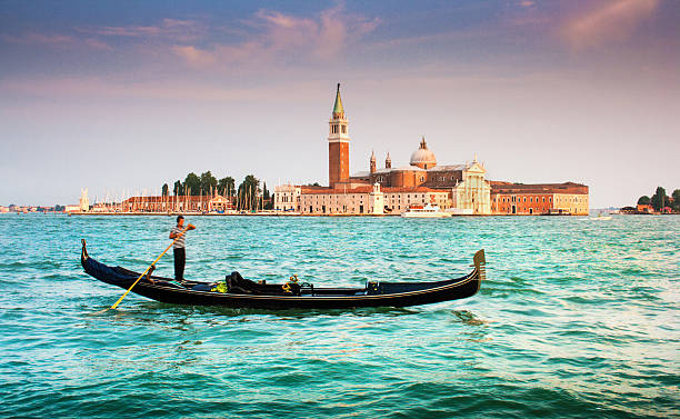 Gondola with San Giorgio Maggiore at sunset, Venice, Italy Beautiful view of traditional Gondola on Canal Grande with San Giorgio Maggiore church in the background at sunset, San Marco, Venice, Italy san giorgio maggiore stock pictures, royalty-free photos & images