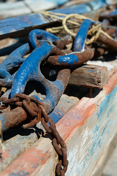 istock Oxidized chain and rustic wood at harbour on mediterranean island 526445587