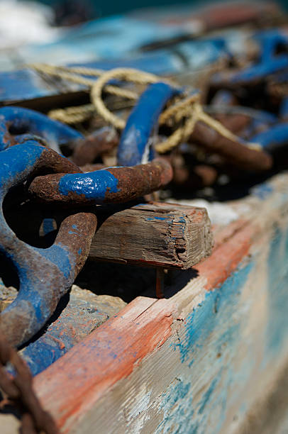 istock Oxidized chain and rustic wood at harbour on mediterranean island 526445611