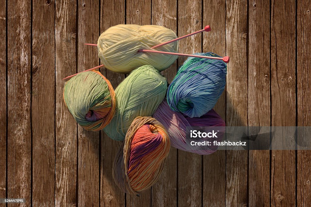 colorful yarn balls knitting on wood background This is a photo of colorful yarn balls on wooden background horizontal image Abstract Stock Photo