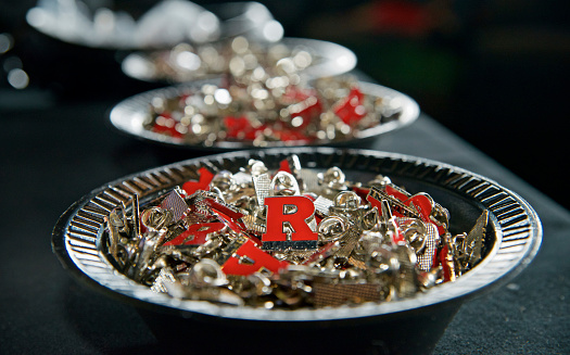 Camden, NJ USA - May 23, 2013; At the annual graduation event of Rutgers University at Susquehanna Bank center in Camden, NJ pins with the university's logo lay in a bowl for graduates to take away as memorabilia of the event. (photo by Bas Slabbers)