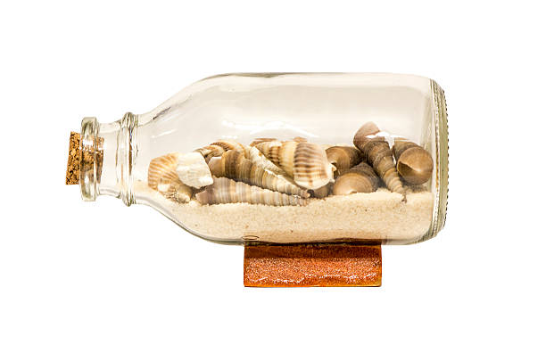 Isolated bottle with shells stock photo