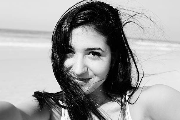 istock Beautiful girl smiling on the beach 526466535