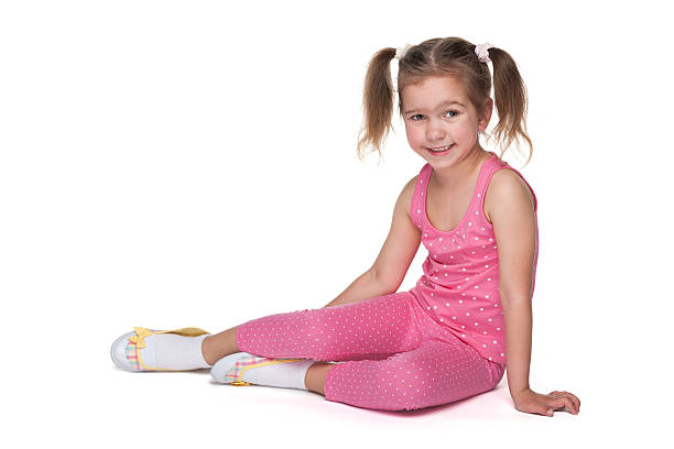 istock Pretty little girl sits on the floor 526467883