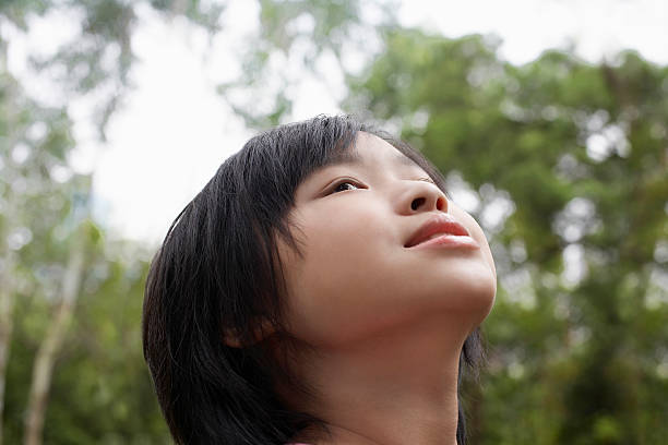 istock Girl Looking Up In Park 526470309