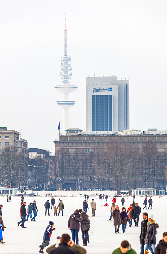 Hamburg, Germany - February 14, 2010: People on the frozen lake Alster in Hamburg. The event takes places only a few days. The ice thickness takes at least 20cm. The conditions  exits twice per decade.