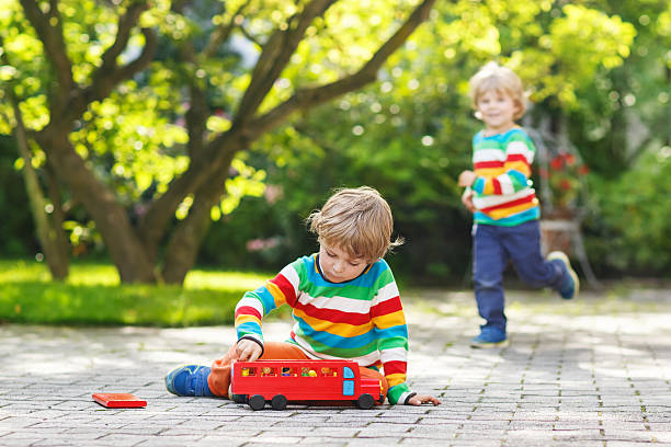 istock Little preschool boy playing with car toy 526470767
