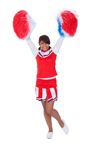 istock Smiling beautiful cheerleader with pompoms 526471783
