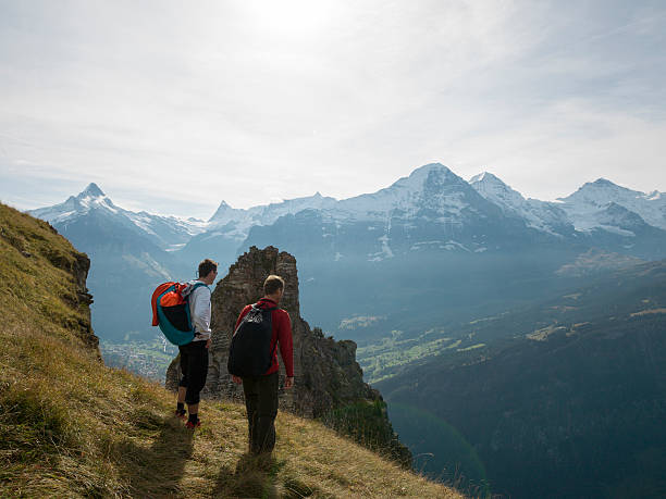 istock BASE jumpers approach edge of cliff 526471829