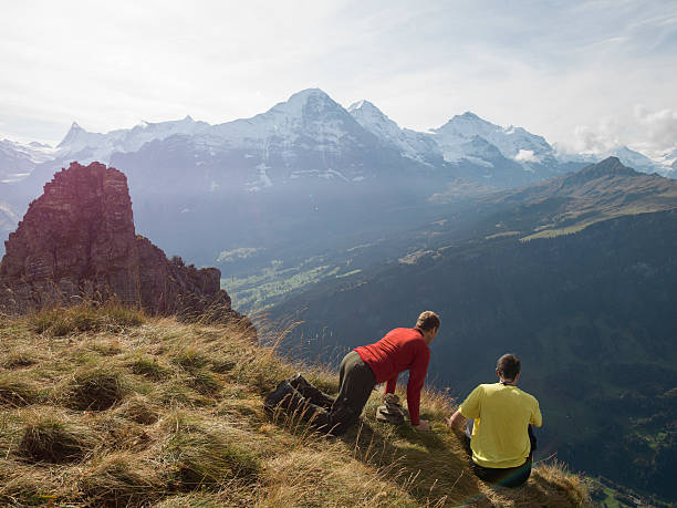 istock BASE jumper look down from edge of cliff 526471841