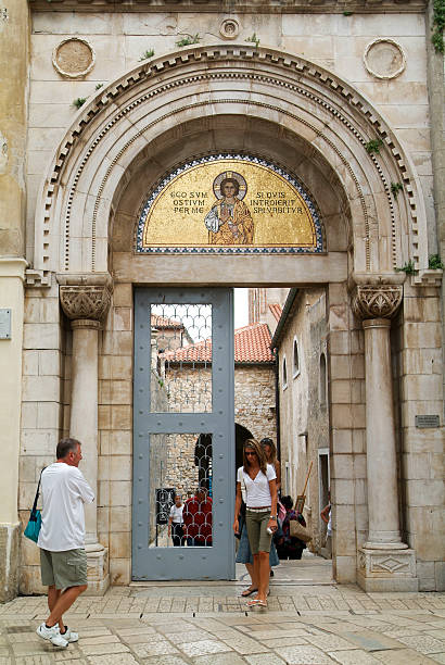 Porec, Croatia - 23 August 2005: People at the entrance door of the Euphrasian Basilica at Porec on Croatia