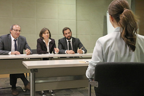 caucasian delegates sharing opinions about colleague speech, adult female talk something in the ear of senior gray bearded man in suit, discussing