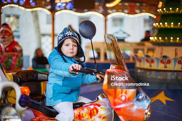 Adorable Little Child On Carousel At Christmas Funfair Or Mark Stock Photo - Download Image Now