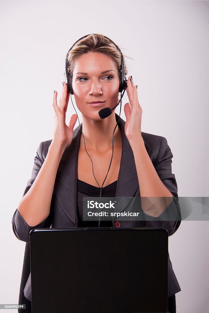 Business woman Business woman talking on headphones Adult Stock Photo