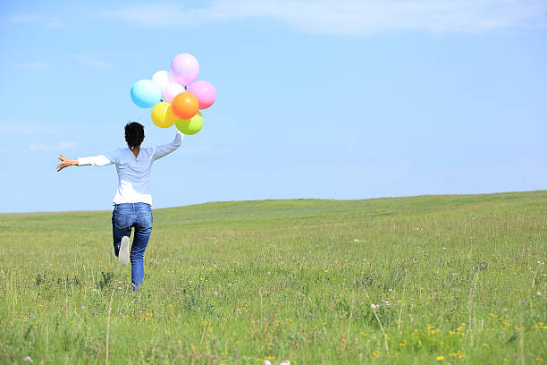 istock young asian woman  with colored balloons 526495547