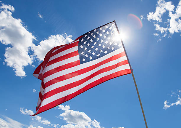 istock USA flag on blue sky background 526504641