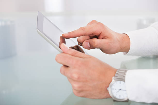 istock Cropped image of businessman's hands using digital tablet 526505059