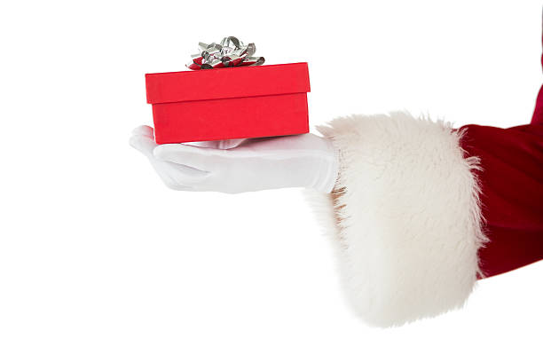 istock Hand of santa claus holding a gift 526505563