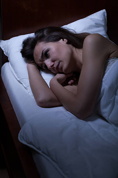 istock Woman lying in bed awake 526506631