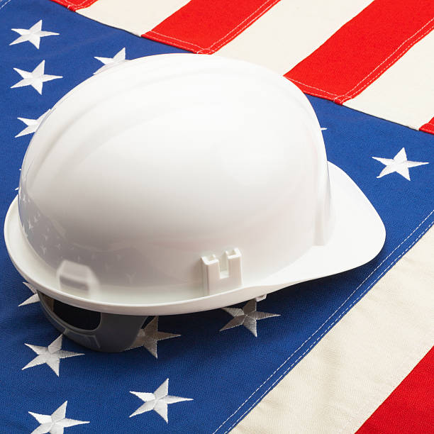 istock White construction helmet over US flag - closeup shot 526508161