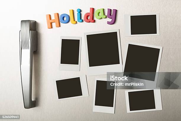 Holiday Magnetic Letters And Blank Polaroid Prints On Fridge Door Stock Photo - Download Image Now