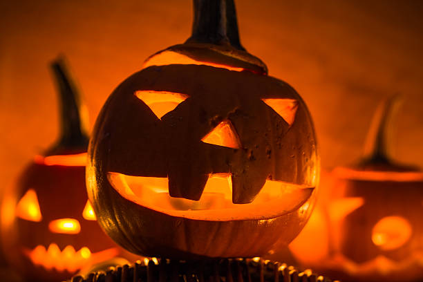 istock Halloween pumpkin lanterns dark light angry face fall 526510353