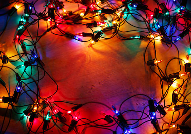 istock Christmas lights frame on wood background with Merry Christmas 526510689