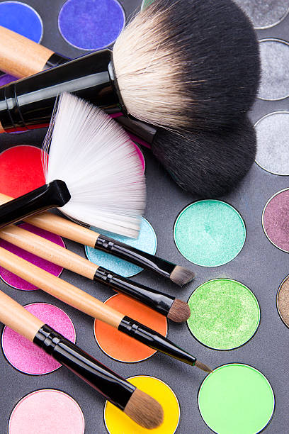 istock close up of make-up brushes and colorful eyeshadow palette over 526530947
