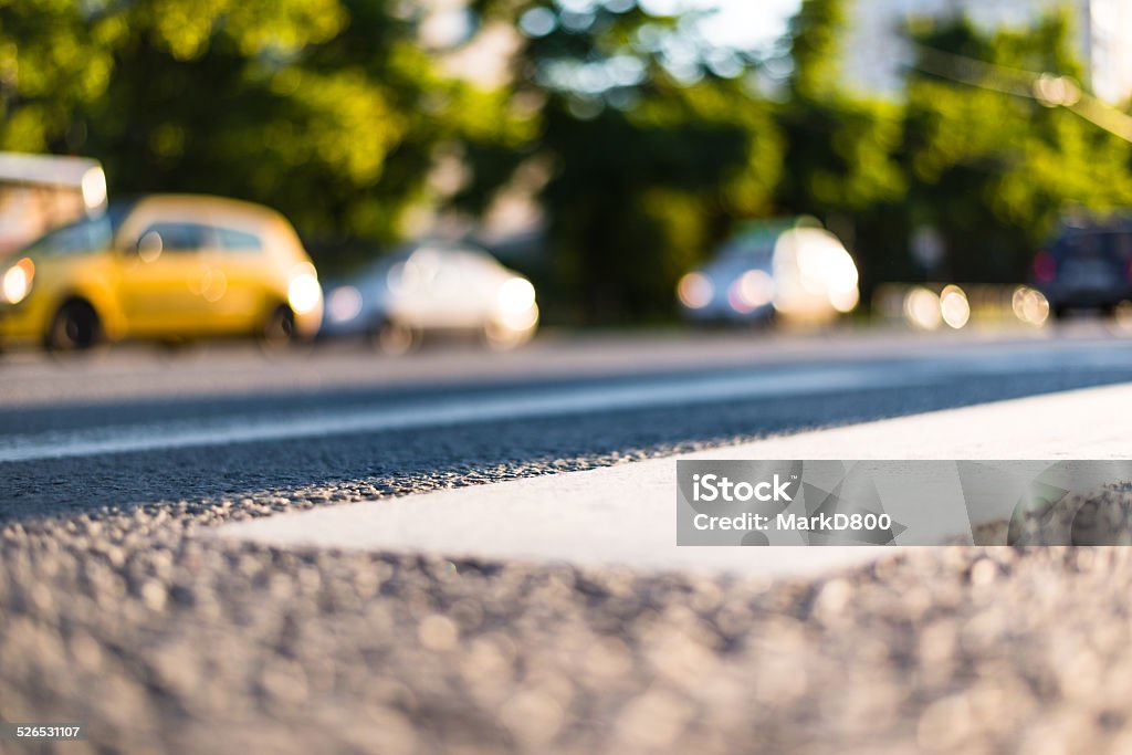 On the road On the road in the city, moving cars and sunlight Arranging Stock Photo