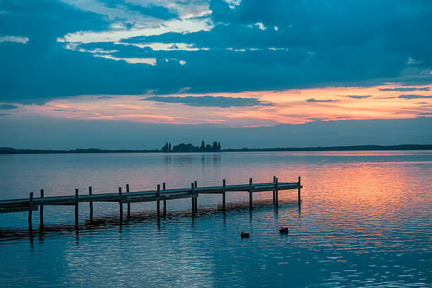 istock Lakeside Jetty and majestic Sunset Cloudscape 526531291
