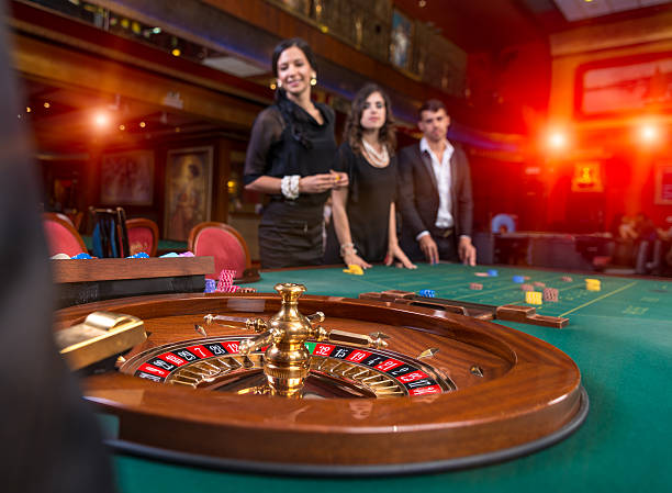 Group of young people playing roulette Group of young people playing roulette roulette photos stock pictures, royalty-free photos & images