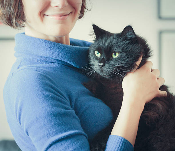 istock Smiling woman with black cat 526532709