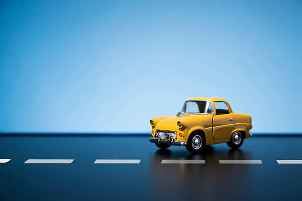 Yellow fifties toy model car. Classic fifties scale model toy car from front view. toy car stock pictures, royalty-free photos & images