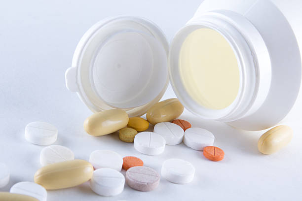 istock close up of colorful pills pouring from plastic bottle 526534621
