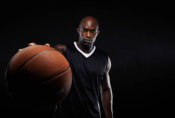 istock Professional basketball player against black background 526535185