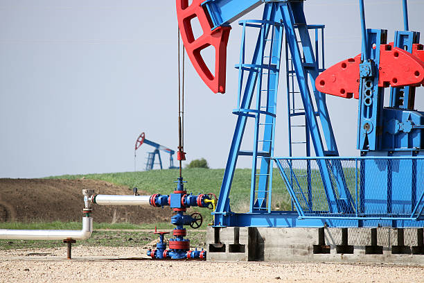 istock two oil pump jack and pipeline 526535303