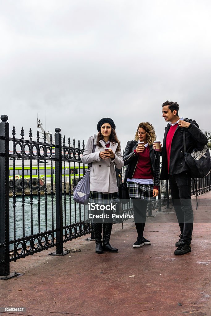 Turkish Students Leaving Ferryboat, Commuting to School, Istanbul Turkish students leaving the ferry over Bosporus, going to school. Cold autumnal morning. Nikon D3x High iso. Focus on woman 18-19 Years Stock Photo